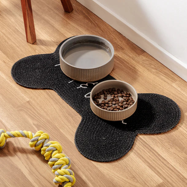 Black Benedict Pet Placemat with two bowls on top – organic cotton bone-shaped feeding mat for pets