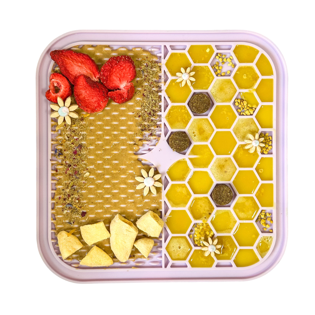 Lavender calming lick mat for pets topped with peanut butter and treats, BPA-free silicone enrichment mat for dogs and cats.