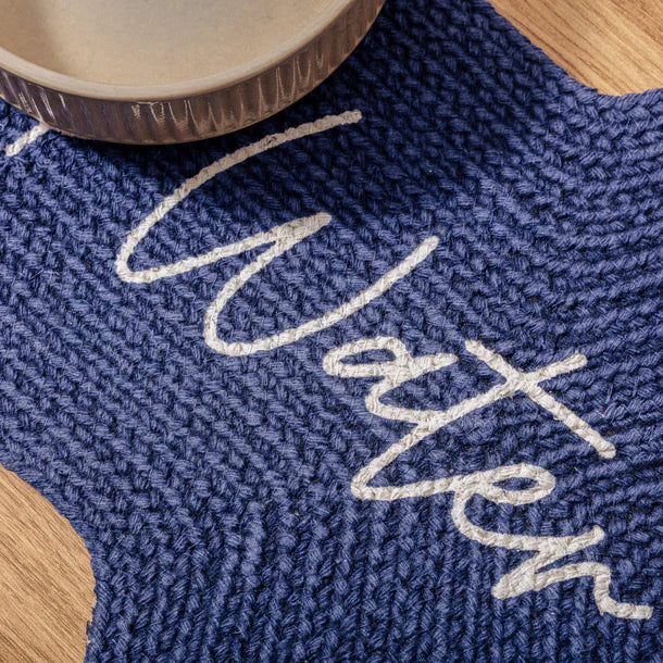 Close-up of Benedict Pet Placemat – organic cotton bone-shaped feeding mat with ‘Food’ and ‘Water’ text”