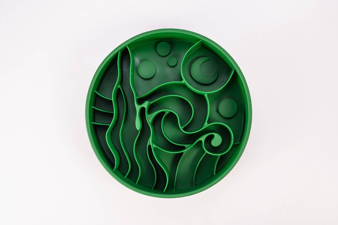 Forrest green Starry Night Slow Feeder Dog Bowl on a green background, made from BPA-free silicone with suction cups.