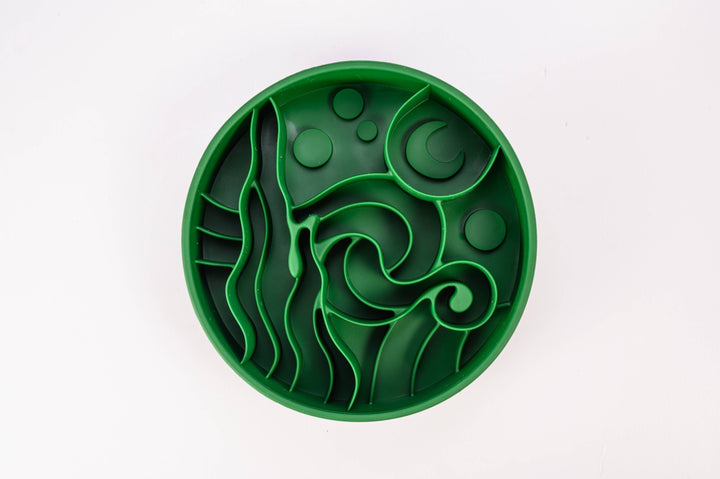 Forrest green Starry Night Slow Feeder Dog Bowl on a green background, made from BPA-free silicone with suction cups.