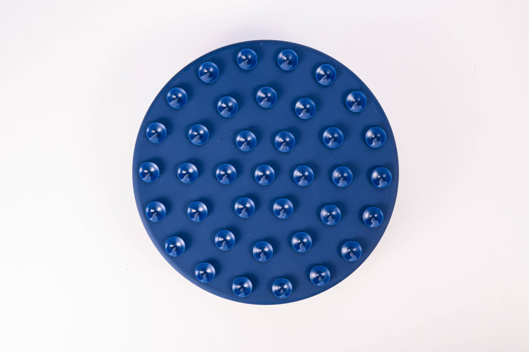 Bottom view of the Midnight dark blue Starry Night Slow Feeder Dog Bowl on a white background, showing strong suction cups.